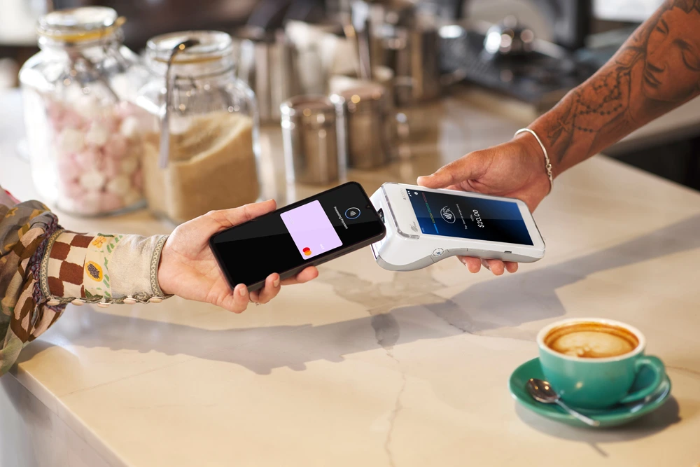 Coffee merchant receiving mobile contactless payment on A920 Terminal
